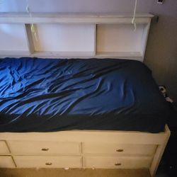 Twin bed with dresser and storage space