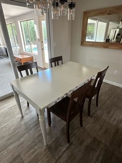 White Dining Table with 4 Dark Wood Chairs