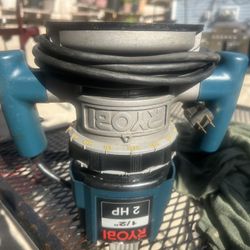 This is a Ryobi 2 HP Plunge Base Router. It has a 10-amp variable-speed motor