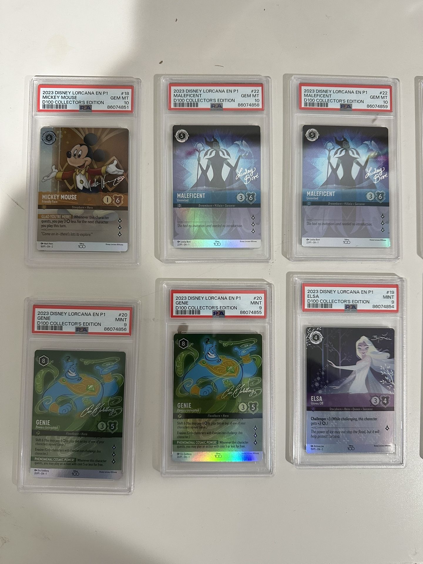 Graded Lorcana D100 Cards and The First Chapter Sleeved Blisters