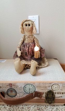 A girl hold electric candle 15" long 9" sitting size new!