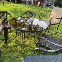 A Beautiful Set Of A Glass Table, With 2 High Chairs, 3 Regular Chairs , A Very Creative Way For Your Patio