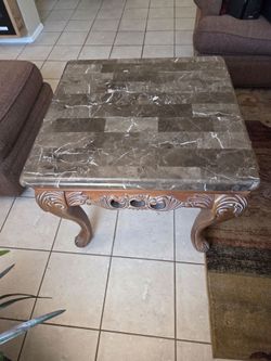 End table brown granite top, set on carved wood base