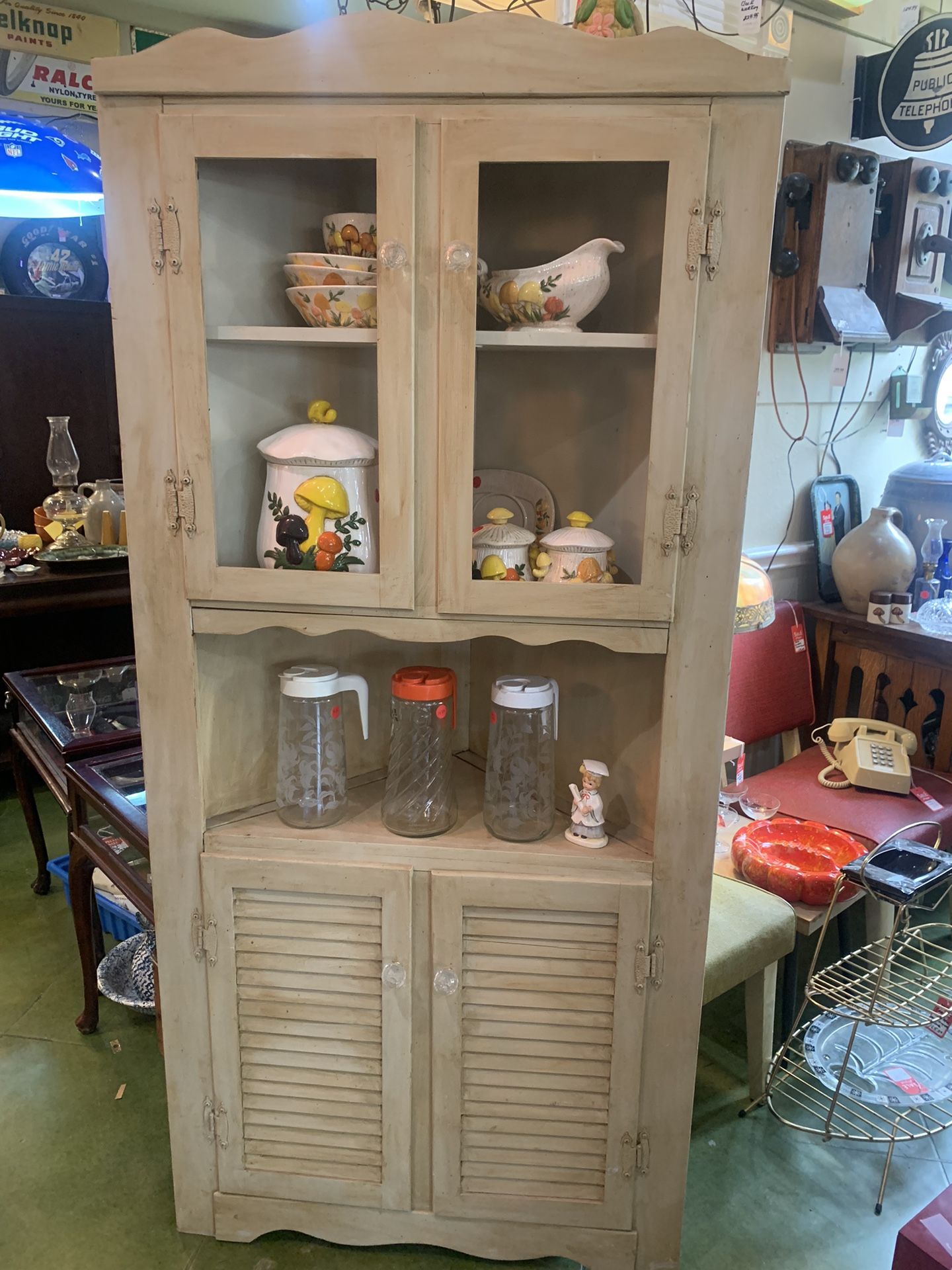 32x22x69 vintage corner cabinet. Fits in corner of room.  165.00 Top and bottom storage.  No glass on top doors.  Johanna at Antiques and More. Locate