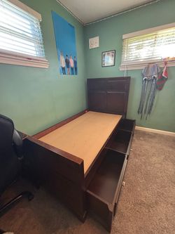 Twin wood bed frame with headboard and storage.