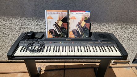 Yamaha electronic keyboard with stand and course books