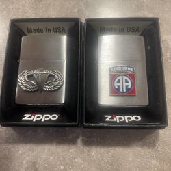 Two zippo  military lighters 82nd airborne and jump wings. 