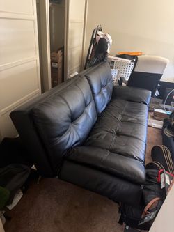 Black leather faux leather couch/ futon