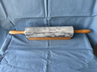 White marble rolling bin with wooden handles and base
