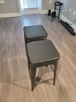 Two bar height studded stools