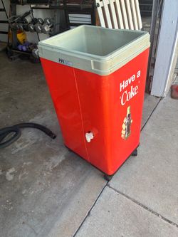A retro-style Coca-Cola rolling cooler that