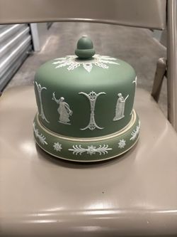 This is a Wedgwood Jasperware cheese dish, likely dating from the Victorian era around the 1870s, known for its iconic sage green ground and white spr