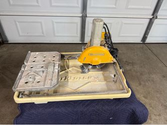 7 INCHES WET SAW TILE CUTTER IN GOOD CONDITION. $80.00 OR BEST OFFER. .