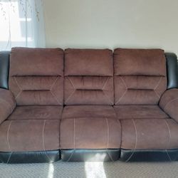 Ashley Earhart Faux Leather Manual Dual Sided Reclining  Sofa