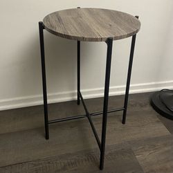 Round Side Table •Wooden top with Black Cross Metal Leg •Height 24" •Diameter 15.75" •in mint condition  