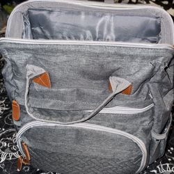 Diaper bag with changing station and plug in port