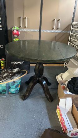 Solid wood, drop sides round dining table. Measures 36 inches across and 30 inches high.
