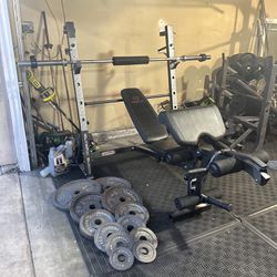 Bench press/ squat rack with 245lbs of Olympic weights plus 7ft bar work clamps