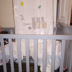 A Crib and Baby Mattress 