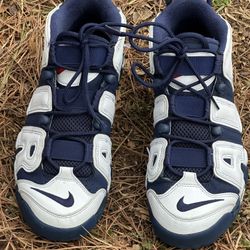 Size 9 the Nike Air More Uptempo in the iconic "Olympic" colorway, a classic high-top basketball sneaker 