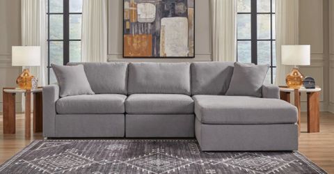 L-shaped interchangeable L grey couch.