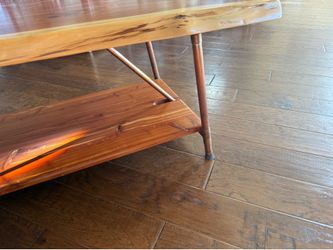Natural wood with brass legs coffee table.