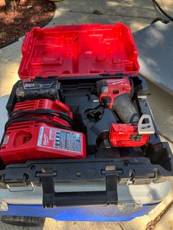 M18 impact driver with case and charger and battery.