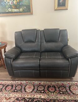 Costco Leather Power black recliner loveseat, only 3 months old, like new, moving must sell.