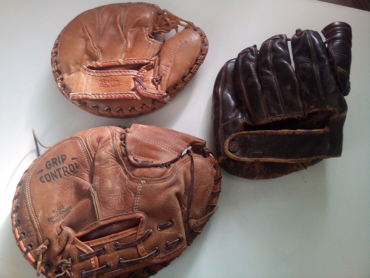 Three vintage baseball gloves sold all together
