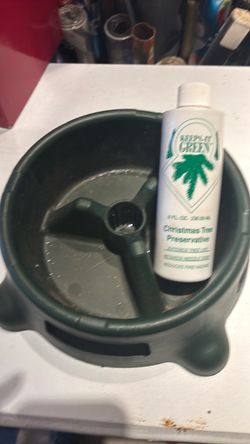 Real Christmas tree stand with preservatives to extend tree life.