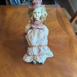 Porcelain doll In Rocking Chair