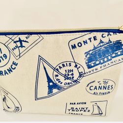 Large Makeup/cosmetic bag. 9” x  7” x 3” Lancôme Brand, With French Icons all over ivory canvas fabric. Comes from a smoke free environment.  