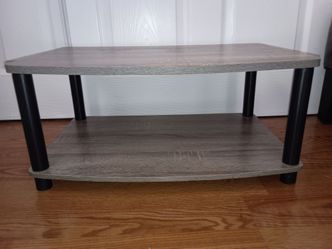 TV stand. Small stand. Grey with grain design. Retail $40.