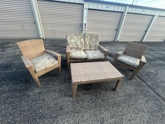 Wicker porch patio set featuring two armchairs a loveseat coffee table & 8 cushions