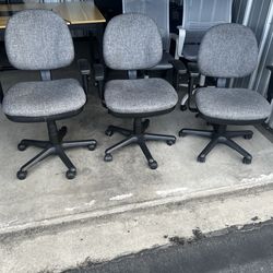 3 gray adjustable height rolling office chairs