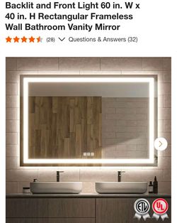 Frameless lit bathroom mirror