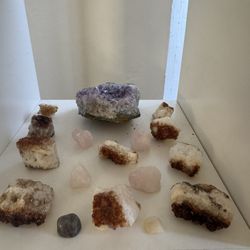 4. Image 4 (Crystals and Minerals Display) 	•	Display shelf with crystals 	•	Amethyst cluster (top center) 	•	Citrine or calcite stones (brown and whi
