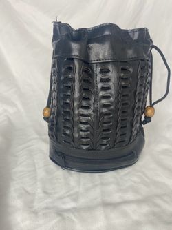 vintage-style black leather cylindrical bucket bag