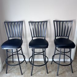 Gunmetal steel swivel counter stool with black leather seat