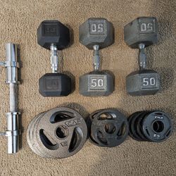 2 Inch Barbell With Weight Locks And Various Weights And 50lb Dumbells