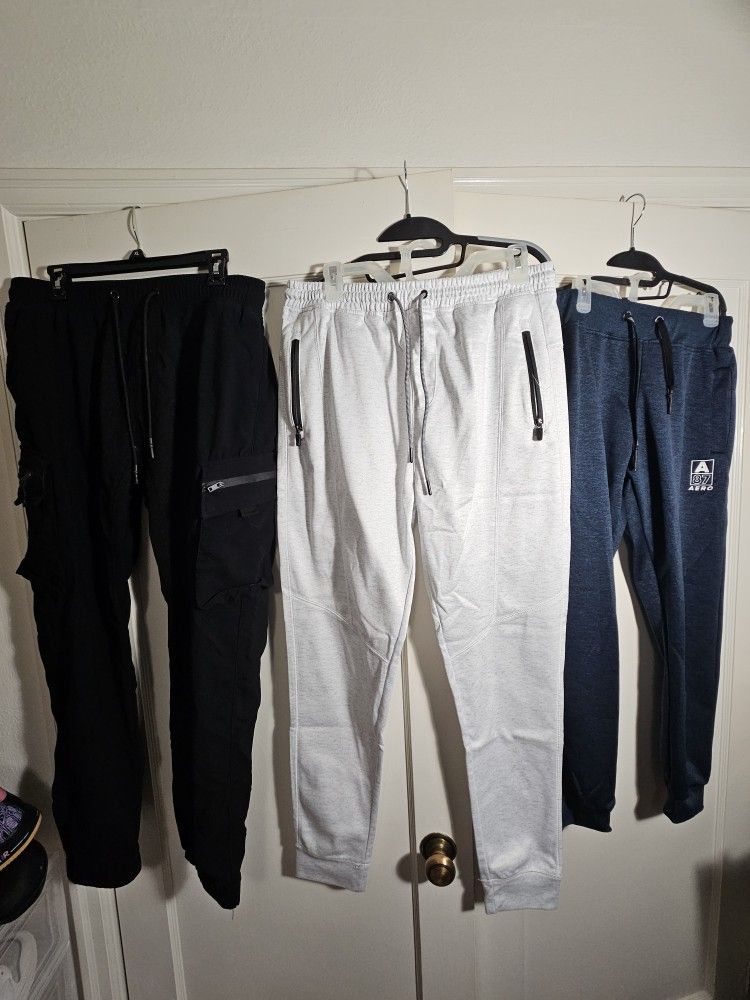 Black tech pants(2xl) along with white and blue sweats(Large)