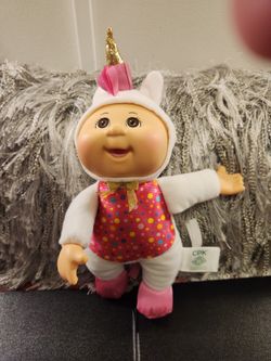 Two Cabbage Patch Kids In Unicorn Costumes.