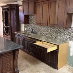 Kitchen cabinets and a refrigerator and a island