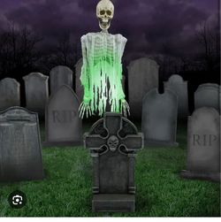 Floating ghost over tombstone
