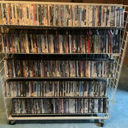 Rolling DVD/bluray/cd/book Rack Will Hold Around 1000 DVDs. 827 Dvds, 16 CDs, 2 PS3, 3 PlayStation 2, 2 Xbox 360 And 6 Blu-ray’s Included. $90 For All