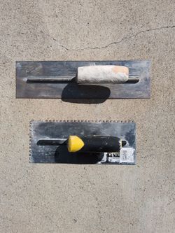 Two Trowel Tools with smooth metal blades.