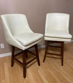 2 WHITE FAUX LEATHER BAR STOOLS ($60.00 FOR BOTH) HEIGHT: FLOOR TO SEAT: 28”