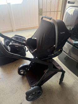 Black Nuna stroller with accessories