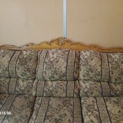 vintage 3-seat sofa with a traditional floral tapestry upholstery in muted tones of beige, green, and blue.