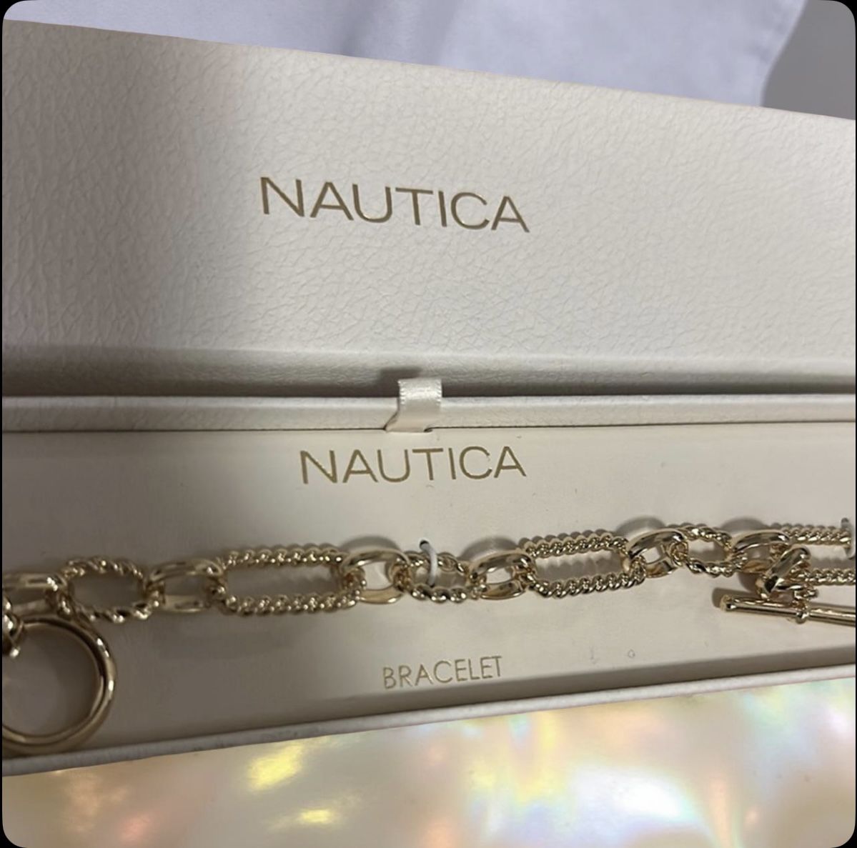 Nautica Gold-tone chain link bracelet with a toggle clasp.